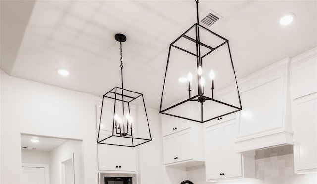 9216 NW 117th St, Yukon, OK 73099 - kitchen view of a chandelier, white cabinets, hanging light fixtures, and recessed lighting
