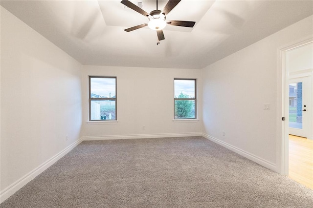 9216 NW 117th St, Yukon, OK 73099 - empty room featuring light carpet, ceiling fan, and baseboards