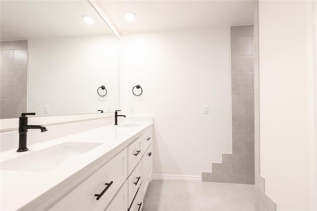 9216 NW 117th St, Yukon, OK 73099 - bathroom with double vanity, tile patterned floors, recessed lighting, and baseboards