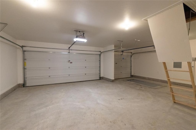 9216 NW 117th St, Yukon, OK 73099 - garage featuring a garage door opener and baseboards