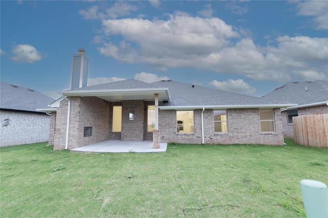 9216 NW 117th St, Yukon, OK 73099 - back of house featuring a patio area, a chimney, brick siding, and a shingled roof