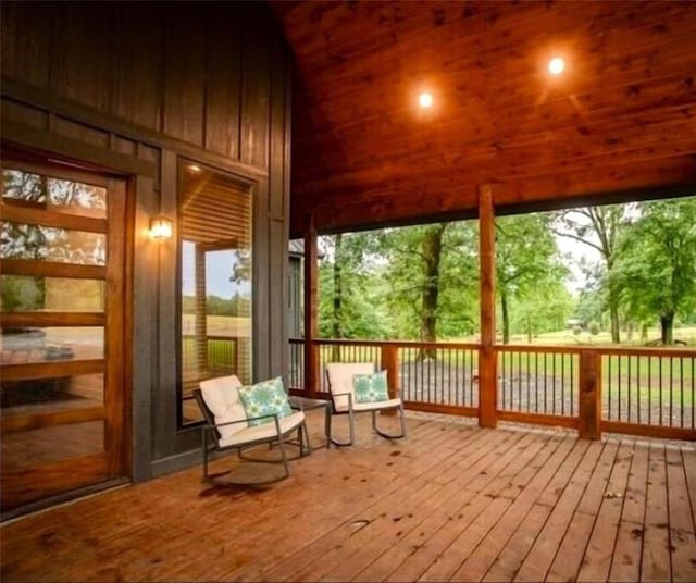 unfurnished sunroom featuring plenty of natural light, lofted ceiling, and wood ceiling