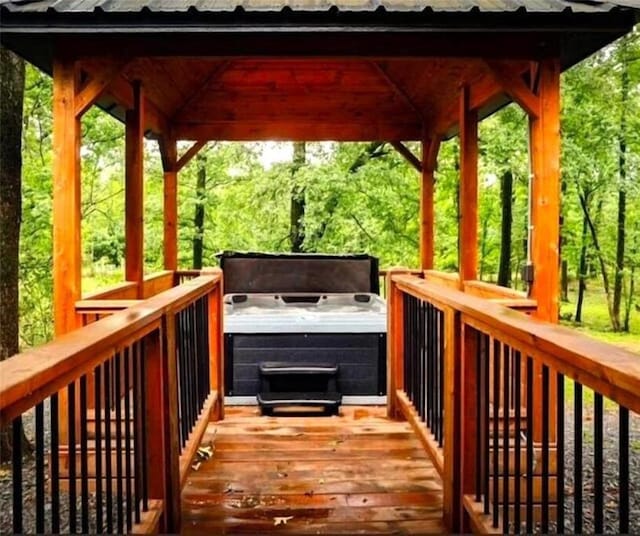 wooden terrace featuring a gazebo, a hot tub, and a grill