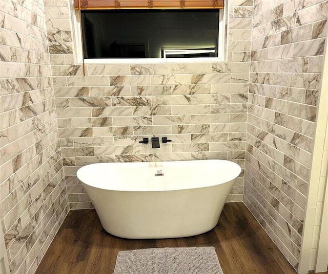 bathroom featuring hardwood / wood-style floors and a tub