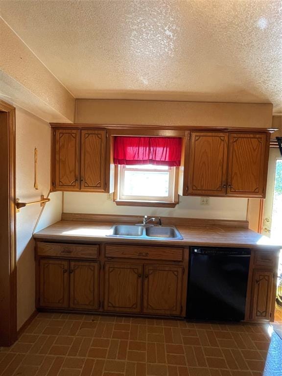 kitchen featuring a textured ceiling, dishwasher, and sink