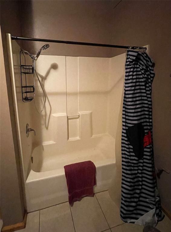 bathroom featuring tile patterned floors and shower / bath combo with shower curtain