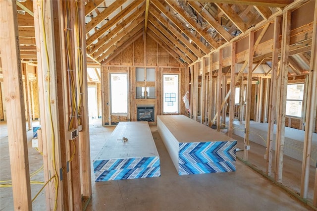 misc room with lofted ceiling and a fireplace