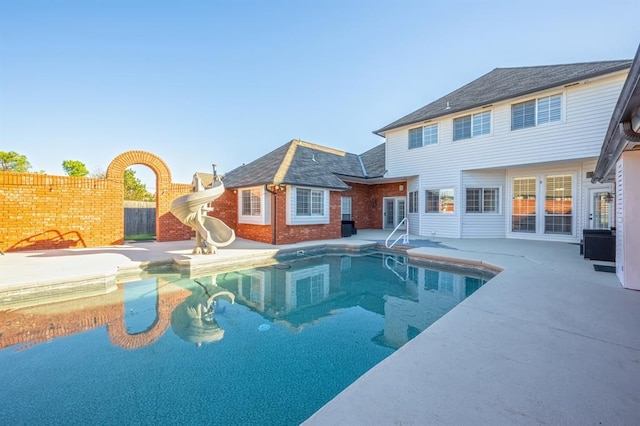 view of pool featuring a patio and a water slide