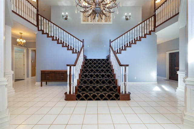 staircase with a towering ceiling and ornate columns