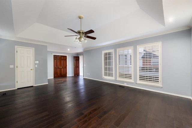 interior space with dark hardwood / wood-style flooring, a tray ceiling, ceiling fan, and crown molding