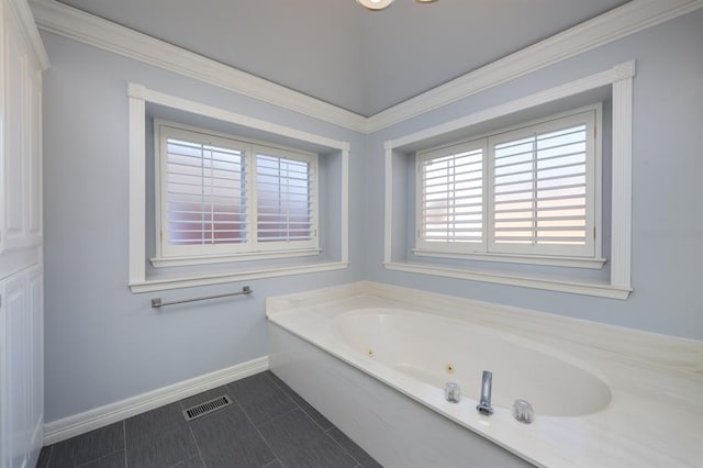 bathroom featuring crown molding and a tub