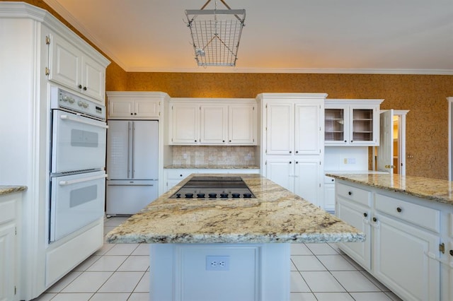 kitchen with white cabinets, white appliances, and a kitchen island