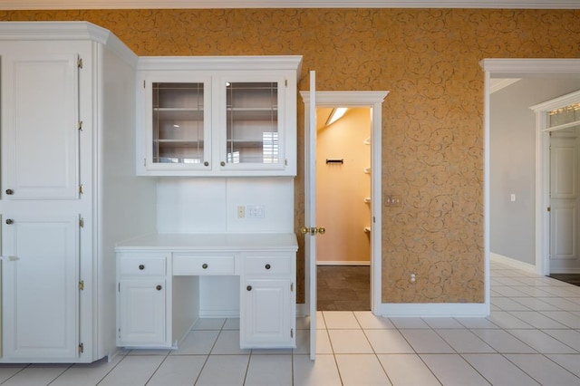 unfurnished office featuring light tile patterned floors and ornamental molding