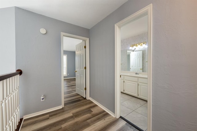 hall with sink and light hardwood / wood-style flooring