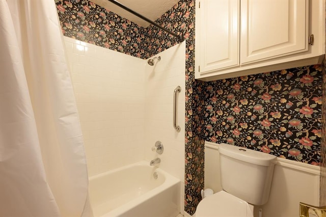 bathroom with shower / tub combo and toilet