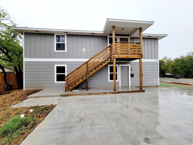 back of property featuring a patio area and a deck