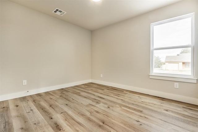 unfurnished room with light wood-type flooring