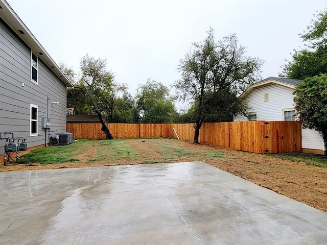 view of yard featuring a patio area and central air condition unit