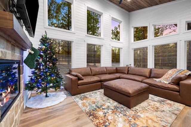 living room with wooden ceiling, a towering ceiling, and wood-type flooring