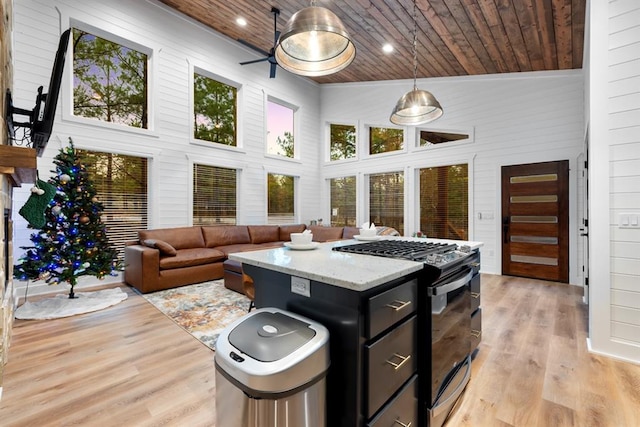 kitchen featuring decorative light fixtures, wood ceiling, black range with gas cooktop, and high vaulted ceiling