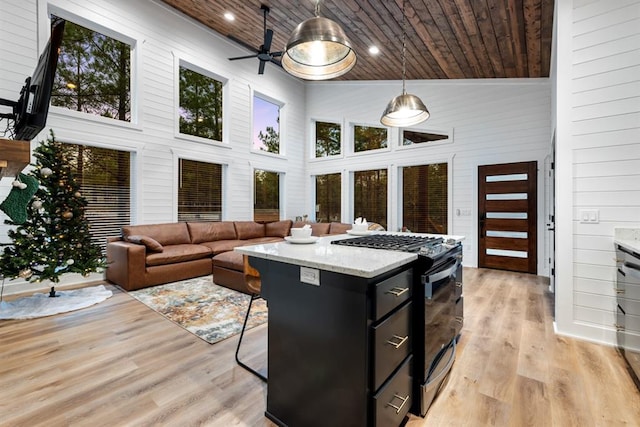 interior space with vaulted ceiling, ceiling fan, and wood ceiling