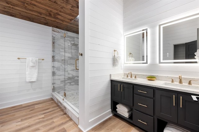 bathroom featuring wooden ceiling, walk in shower, wood walls, vanity, and hardwood / wood-style flooring