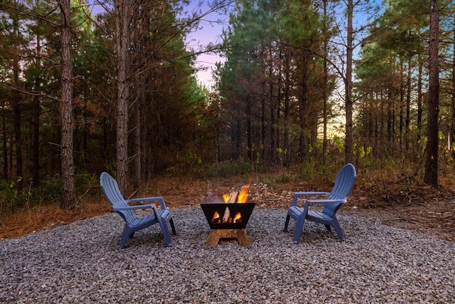 yard at dusk with an outdoor fire pit