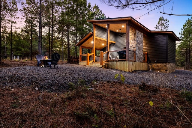 property exterior at dusk featuring a porch