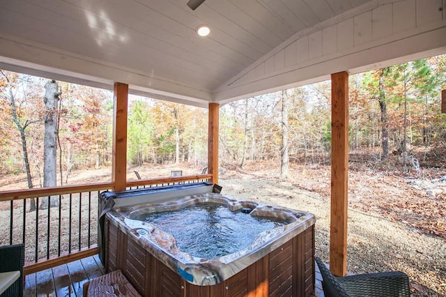 wooden deck with a hot tub