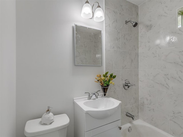 full bathroom with vanity, tiled shower / bath combo, and toilet