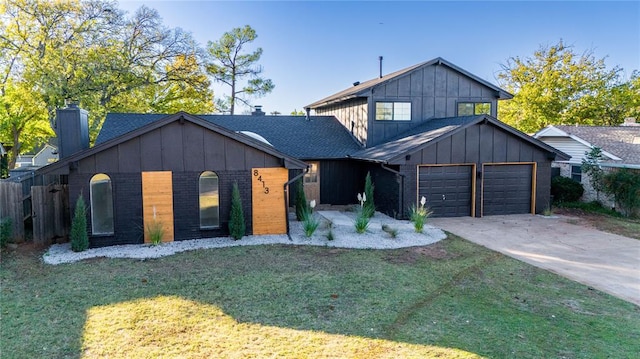 modern farmhouse featuring a front yard and a garage