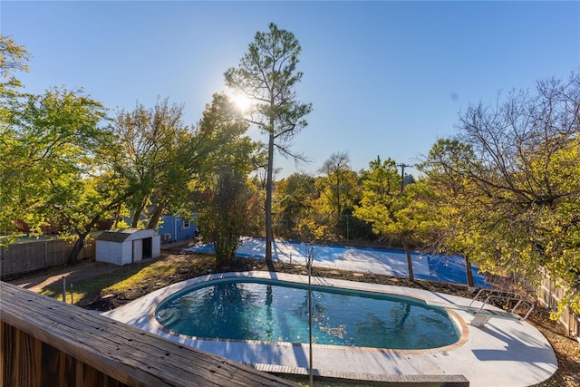 view of swimming pool featuring a storage unit