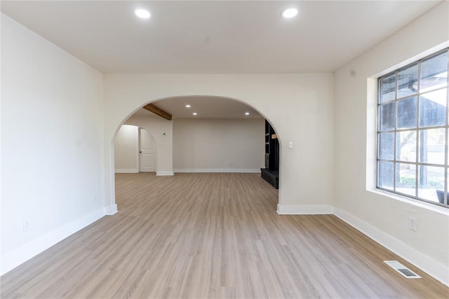 unfurnished living room featuring light hardwood / wood-style flooring and a healthy amount of sunlight