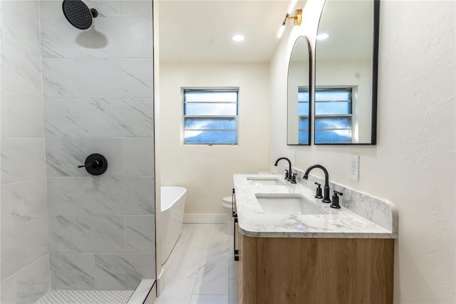 full bathroom featuring vanity, toilet, and shower with separate bathtub