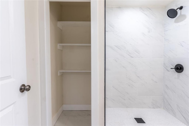 bathroom with a tile shower