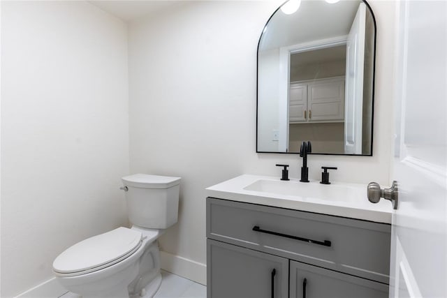 bathroom featuring tile patterned floors, vanity, and toilet