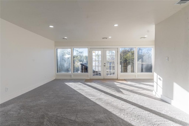 unfurnished living room featuring french doors and carpet floors