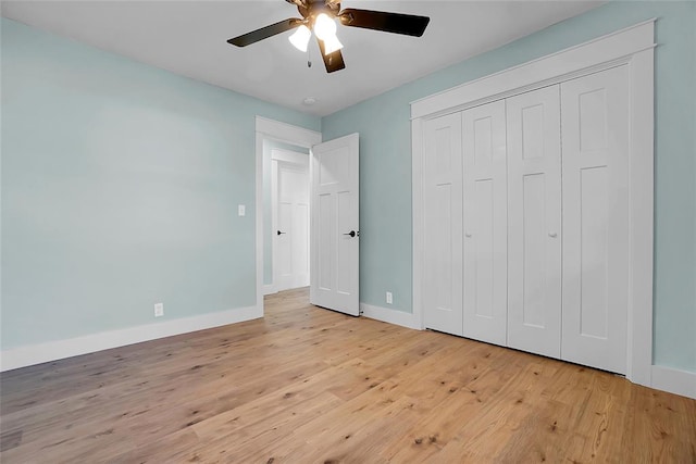 unfurnished bedroom featuring a closet, light hardwood / wood-style floors, and ceiling fan