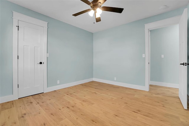 empty room featuring ceiling fan and light hardwood / wood-style floors