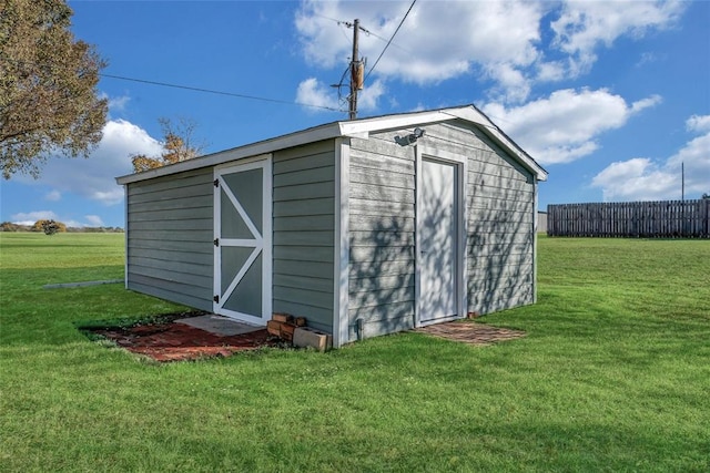 view of outbuilding featuring a yard