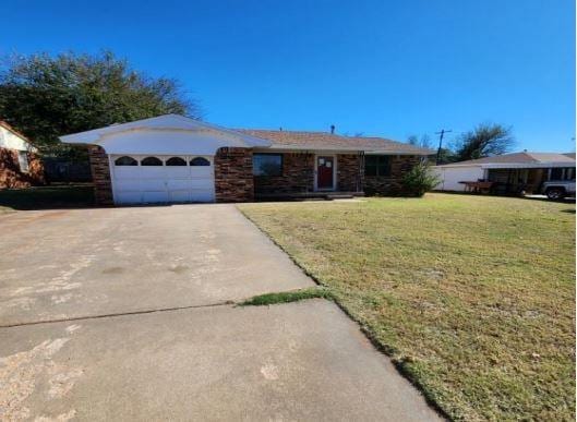 single story home with a front yard and a garage