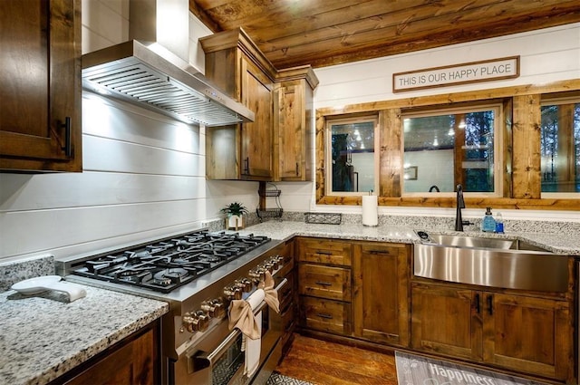 kitchen featuring wood ceiling, sink, wall chimney range hood, double oven range, and dark hardwood / wood-style floors