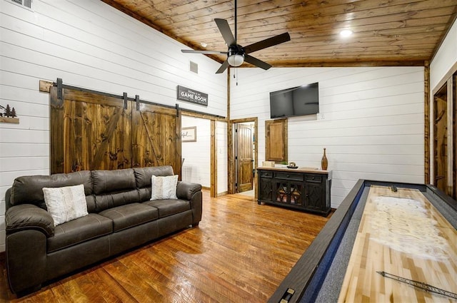 living room featuring hardwood / wood-style floors, a barn door, high vaulted ceiling, and wood ceiling