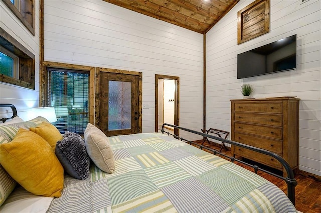 bedroom with wood walls, hardwood / wood-style floors, high vaulted ceiling, and wood ceiling