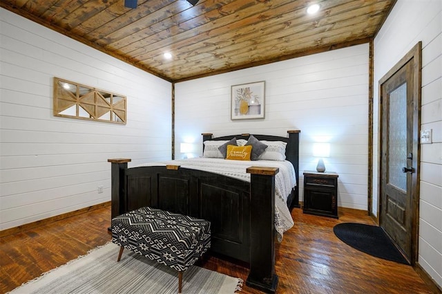 bedroom with wooden walls, dark hardwood / wood-style flooring, and wood ceiling