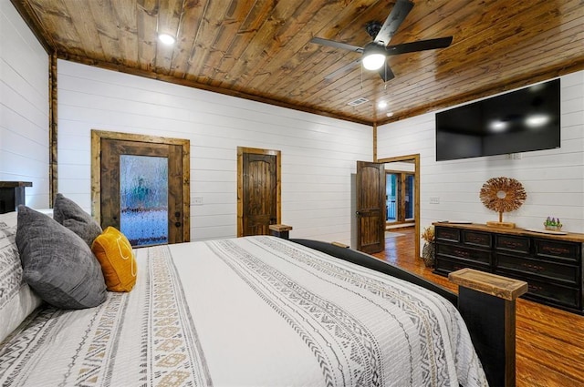 bedroom featuring hardwood / wood-style floors, ceiling fan, wooden walls, and wood ceiling