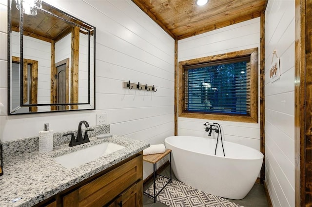 bathroom with vanity, wood ceiling, a tub, and wooden walls