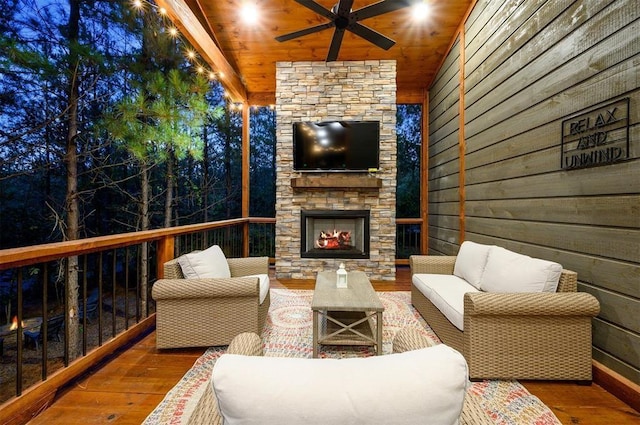 wooden deck featuring an outdoor living space with a fireplace and ceiling fan