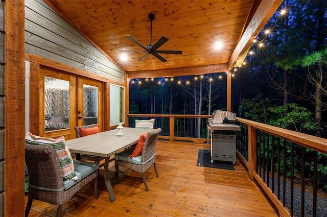 wooden terrace with ceiling fan and a grill