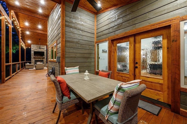 deck featuring a stone fireplace and ceiling fan